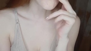 redhead girl smokes a cigarette