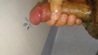 Oily uncircumcised tiny penis gets a quickie jerkoff into a slow motion wall shot cum splurge!
