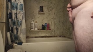 Fat guy jerks dick in shower and swallows own cum