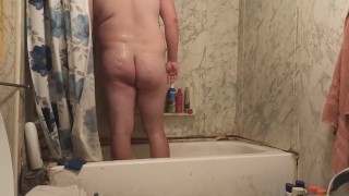 Fat guy jerks dick in shower and swallows own cum