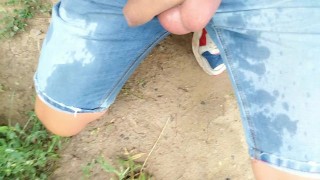 Piss on self and onto ground with uncut cock on outdoor path