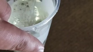 Small cock pissing into cup - urination