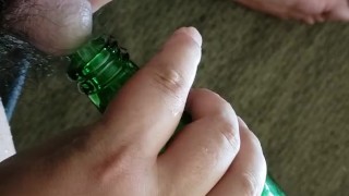 Small cock pissing into bottle - urination