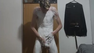 Very skinny teen applies shaving cream on his body and his cock