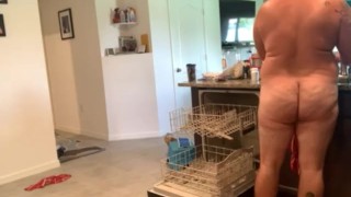 Dad bod naked man doing dishes