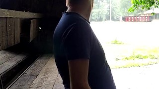 Red headed guy playing with dick outside in the rain while people drive by