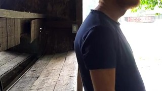 Red headed guy playing with dick outside in the rain while people drive by