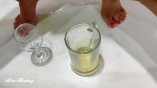 Alice pees in small glass goblet and pours urine into large. Husband makes video and pees on Alice