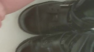 Girl pisses on her black combat boots