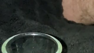 Super close up slow motion trying to cum into shot glass