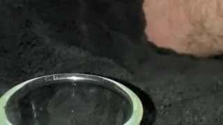 Super close up slow motion trying to cum into shot glass