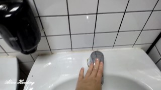 Alice lathers her pussy after using a public toilet in the washbasin