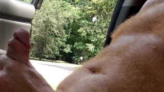 Naked hairy ginger playing with dick while a guy watches and a guy passes on a motorcycle