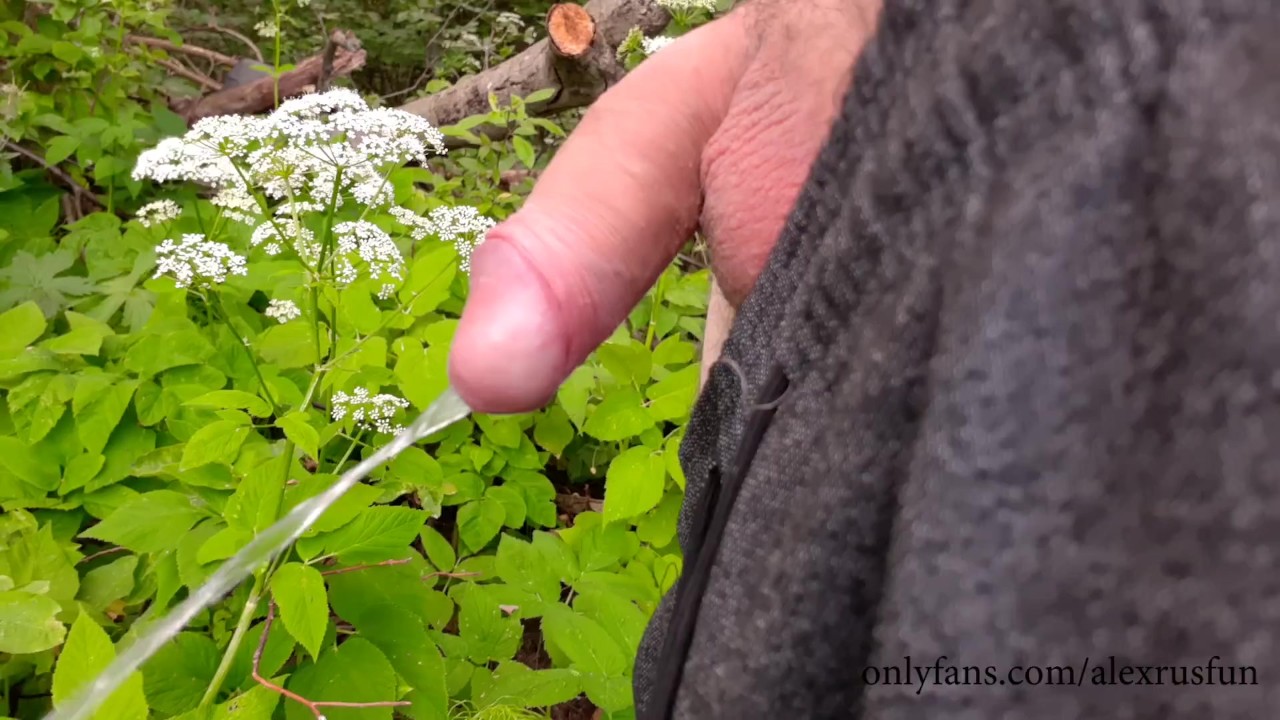 A village guy walking with a dog stopped on the bank of the river took a  piss and jerked off