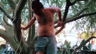 Nudist Hippie peeing from a tree