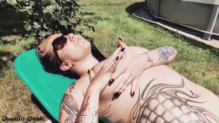 Hot inked girl playing with her big boobs next to the pool