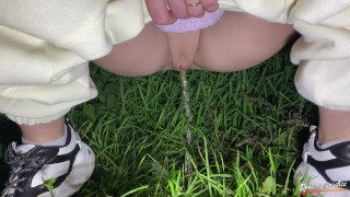A girl pisses in the forest. Pissing in Nature