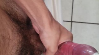 Filling up the tight condon with cum