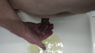 Pissing into the sink and into the foreskin
