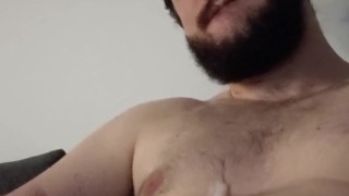 Young otter with beard jerks his big dick and blows a thick load on his chest