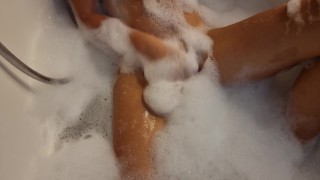 Busty blonde teen masturbates in the bath