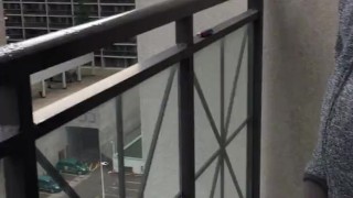 Skinny exhibitionist shows boner on public Toronto balcony while smoking