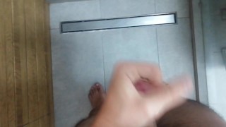 Close-up from the balls upwards. Shower jerking off
