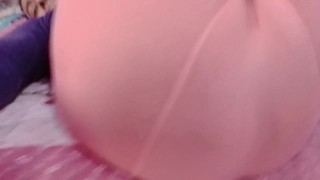 Sexy sissy crossdresser femboy in a pink pantyhose on the bed.