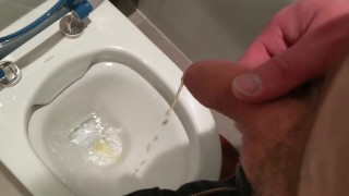Uncut cock pisses at public toilet through big foreskin and dribbles on underwear