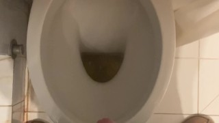 a guy pisses and then masturbates in the bathroom, cumming with his nice cock all over the place