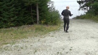 wetsuited silicone masked man on patrol near lake
