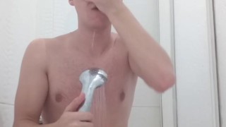 Handsome naked guy takes a shower in front of the camera