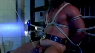 Muscular guy is tied up and had his testicles stretched