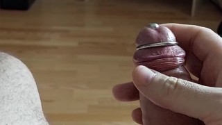 Cumshot through penis urethral plug with glans ring (slow motion cumshot)