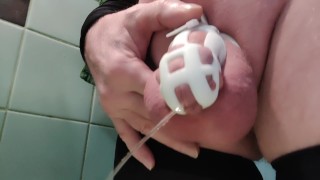 Naughty slut in chastity is pissing in the sink