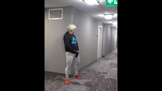 athlete in tights takes his cock out in hotel hall