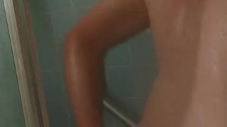 Redhead getting clean in the shower and drying off