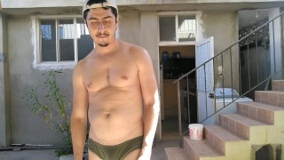 Handsome man showing off hot body in yard