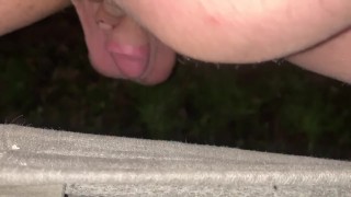 Shaved small cock crouch pissing outdoors 