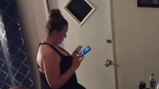 Pretty girl smoking in her night dress while watching tv