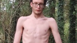Very skinny lad strips outside in the woods in nature and shows off his body while touching himself