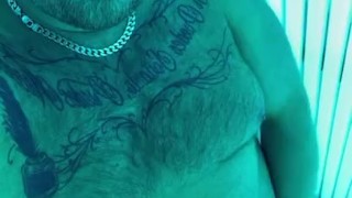 Hairy tattooed daddy with big cock cums on the sunbeds 