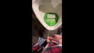Pissing into a urinal in a pub. I play football with urine