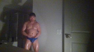 Oiled up and posing while wearing Speedos!