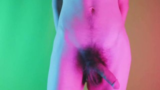 Sensual moves on colored background, showing bulge and hairy soft cock