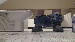 Caged sub offering his hole under the stall