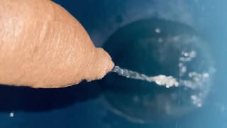 Pissing into bathroom commode 