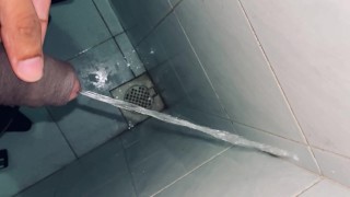 Pissing at the public dirty bathroom edge