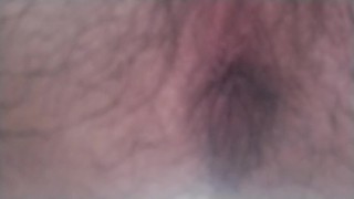 A hairy Japanese man squats and masturbates. The contraction of his anus at moment of ejaculation