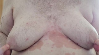 Chubby plays with his fat tits